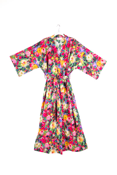 Front view of a limited edition long kimono featuring a light oversized fit, wide sleeves, and a matching belt. The kimono showcases an elegant Japanese-inspired peony print in soft pink tones on high-quality cotton.